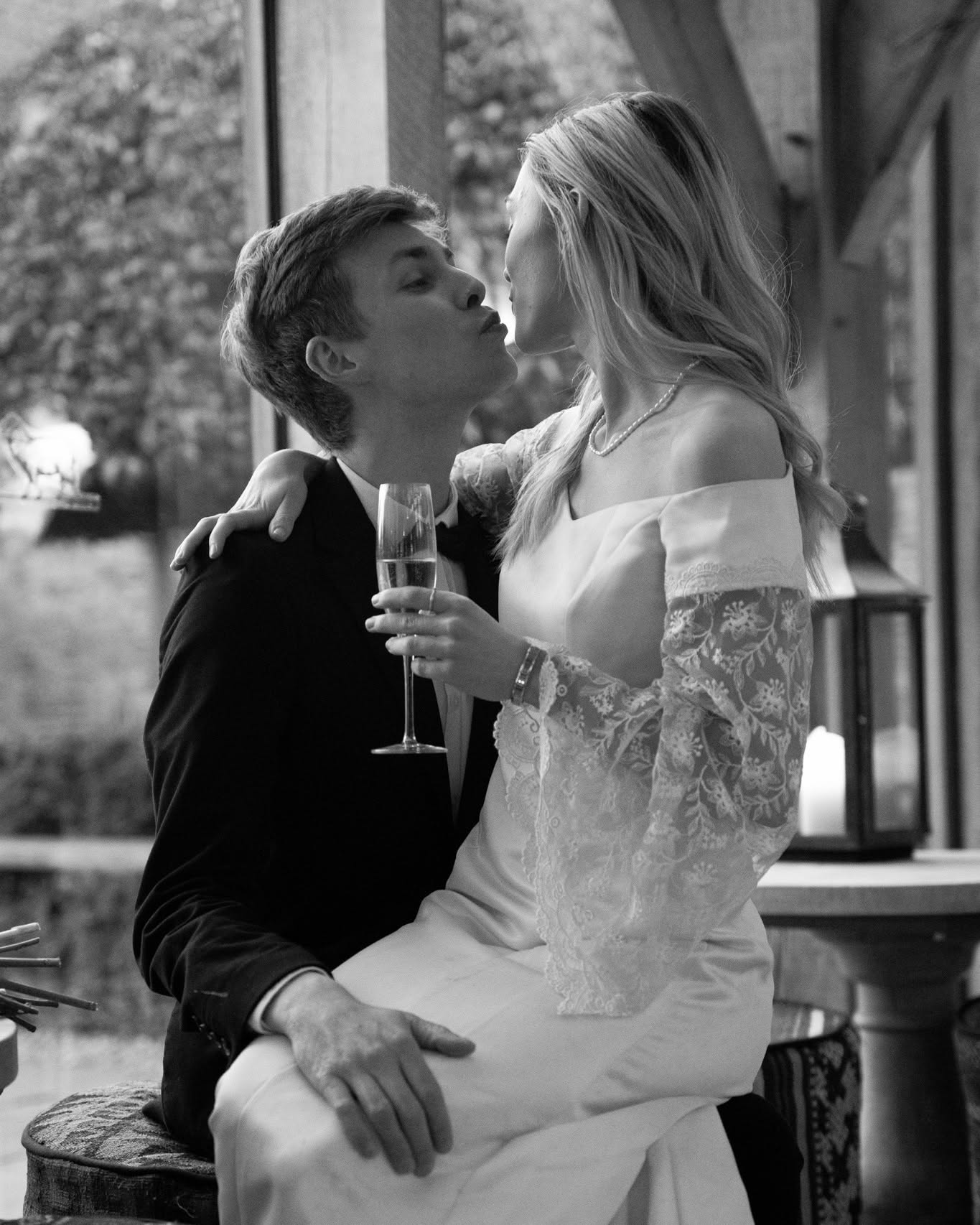 Black and white photograph of a couple sharing a quiet moment over champagne