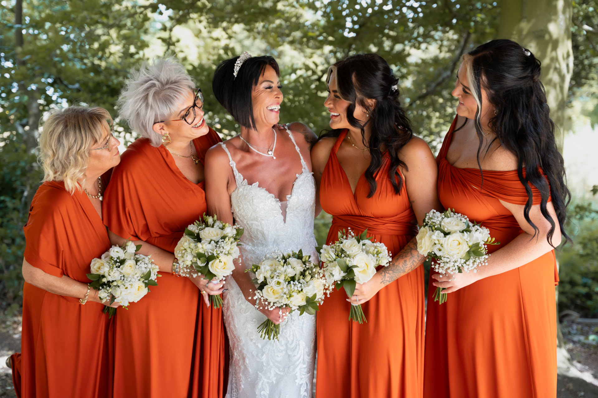 Bride laughing with her bridesmaids